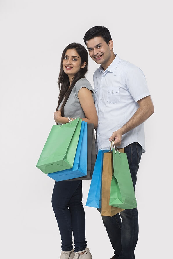 Couple posing with shopping bags while looking at camera