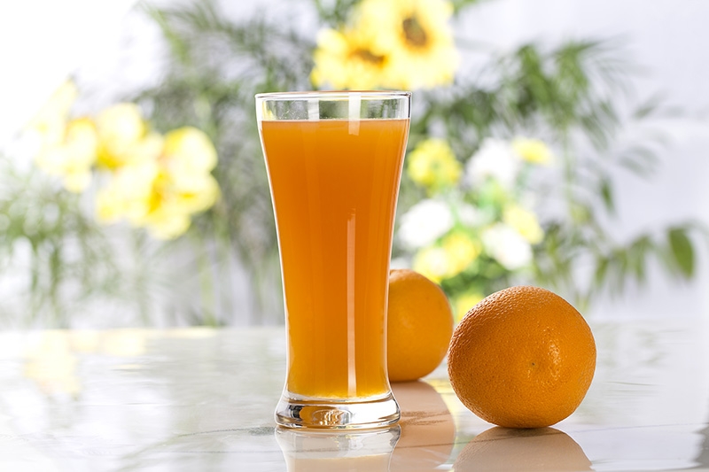 fresh orange juice with flower background