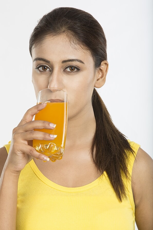 young woman drinking fruit juice