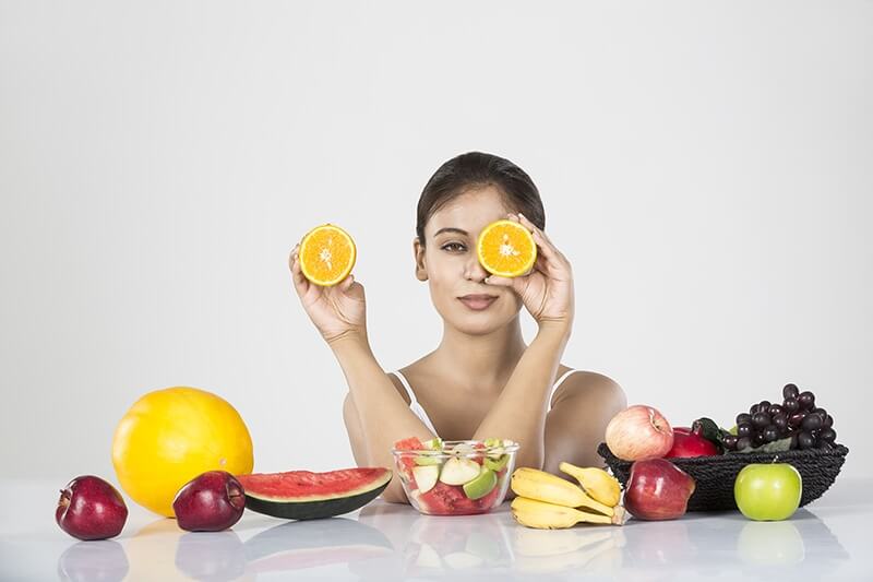 beautiful young woman with fruits
