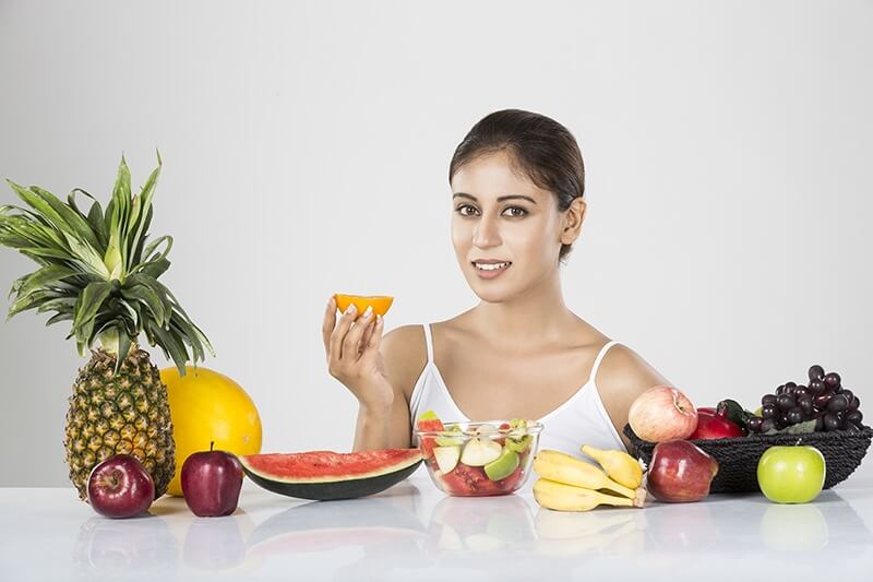 beautiful young woman with fruits
