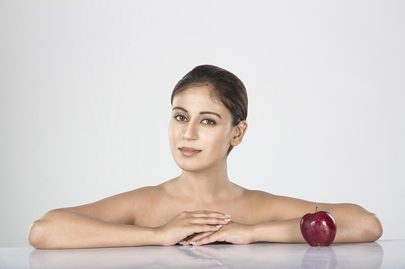 Young woman with red apple