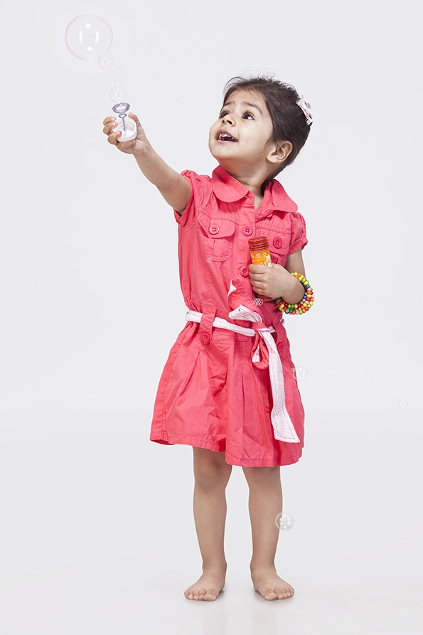 Little girl playing with bubble toy