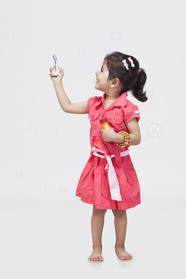 Little girl playing with bubble toy