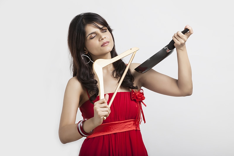Girl playing violin with hanger and pan