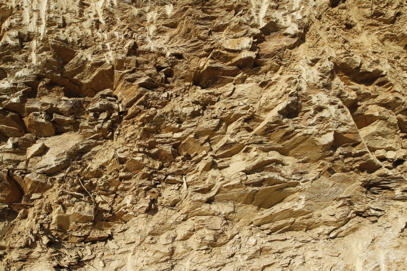 texture of a wall of sandy rock from a yellow friable old rotten stone